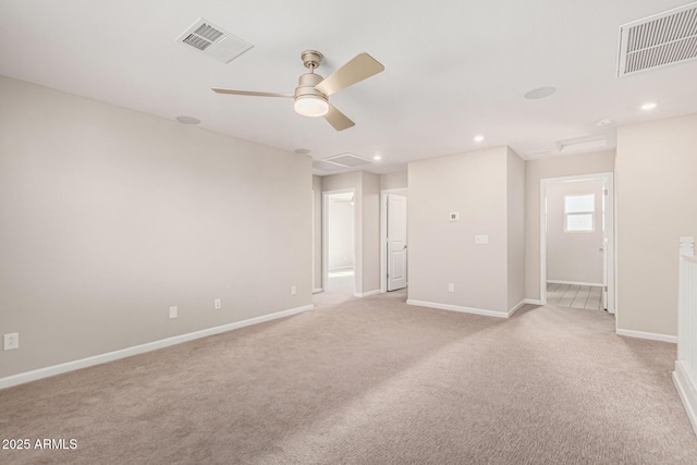 carpeted spare room with ceiling fan