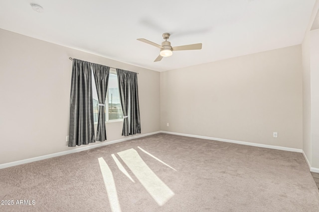 empty room featuring light colored carpet and ceiling fan