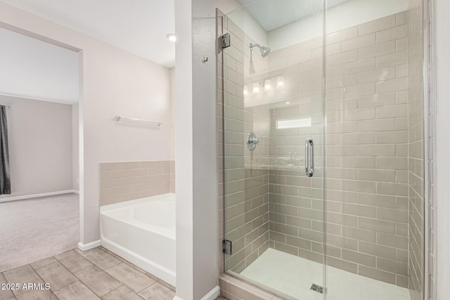 bathroom with separate shower and tub