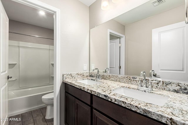 full bathroom with shower / tub combination, vanity, and toilet