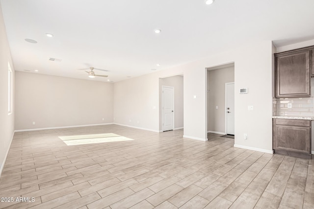 spare room featuring ceiling fan and light wood-type flooring