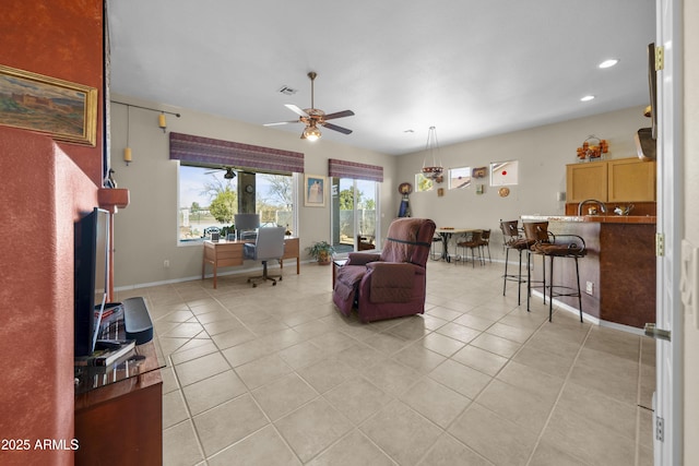 living room with ceiling fan and light tile patterned floors