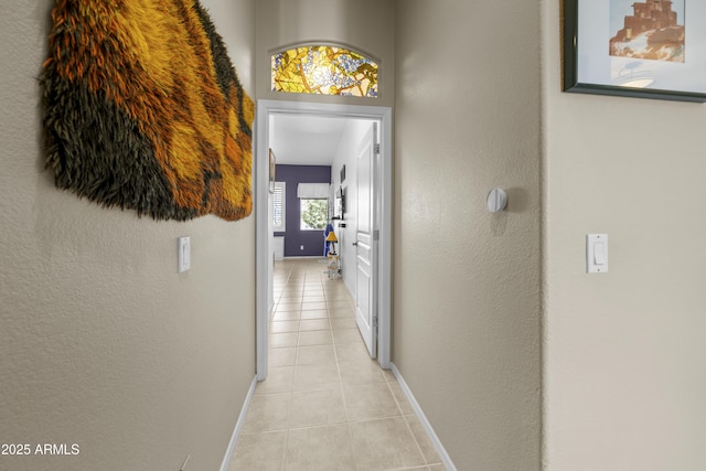 corridor featuring light tile patterned flooring