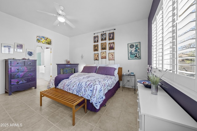 tiled bedroom featuring ensuite bathroom and ceiling fan