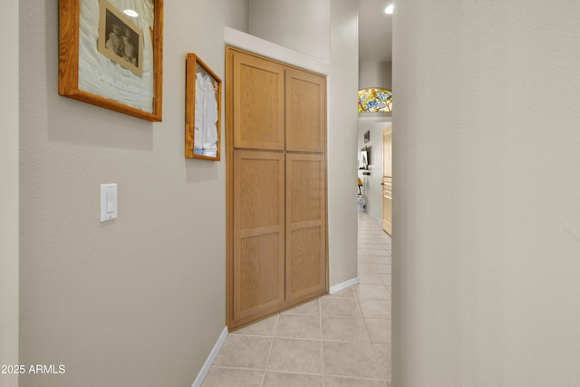 hall featuring light tile patterned floors