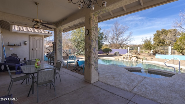 view of patio with a swimming pool with hot tub and ceiling fan