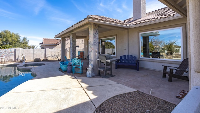 view of patio featuring a swimming pool with hot tub