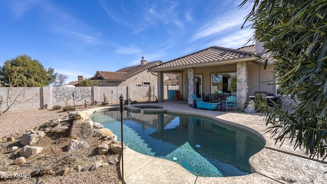 view of swimming pool with an in ground hot tub and a patio area