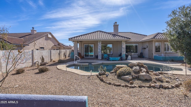 view of pool with an in ground hot tub and a patio area