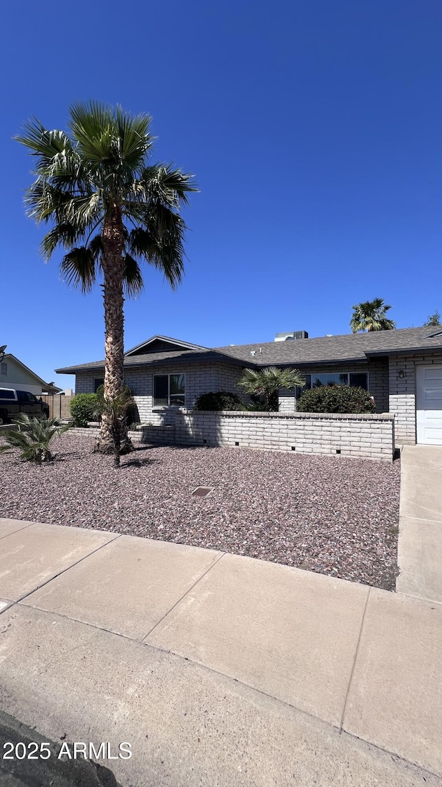 single story home featuring brick siding and fence
