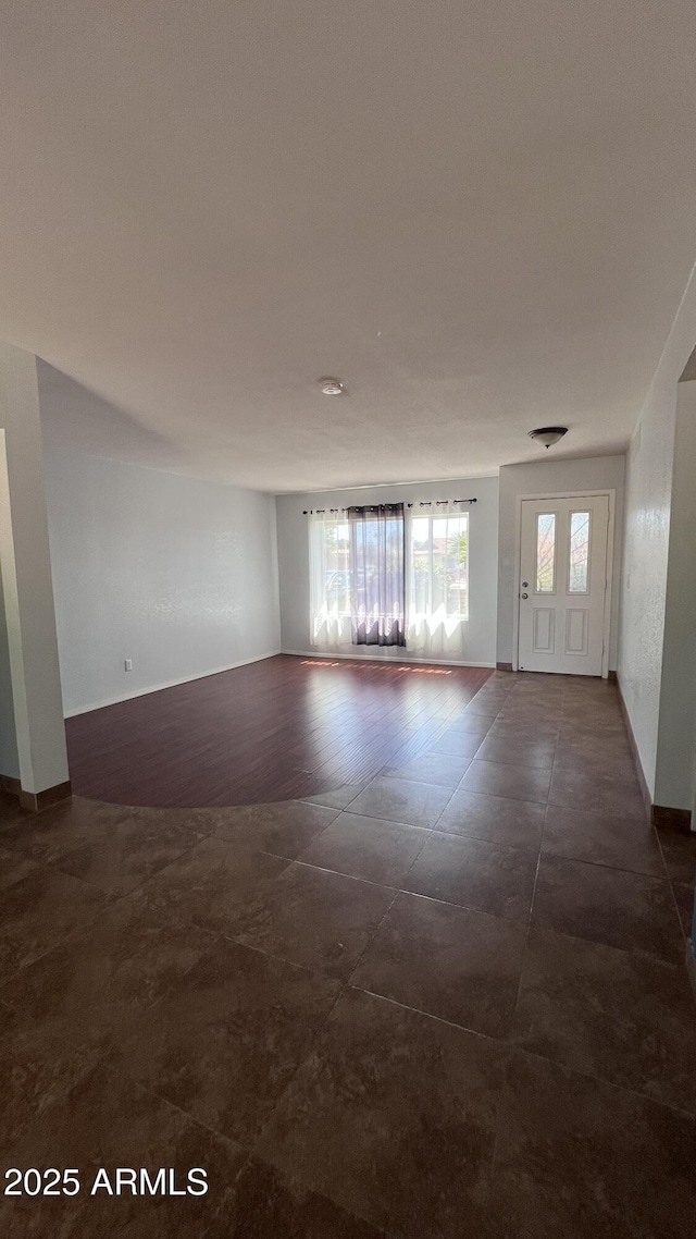 spare room featuring baseboards