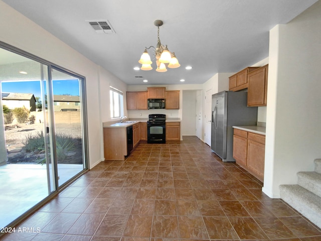 kitchen featuring a chandelier, sink, decorative light fixtures, and black appliances