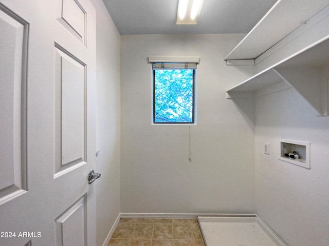 laundry area featuring hookup for a washing machine and light tile patterned floors