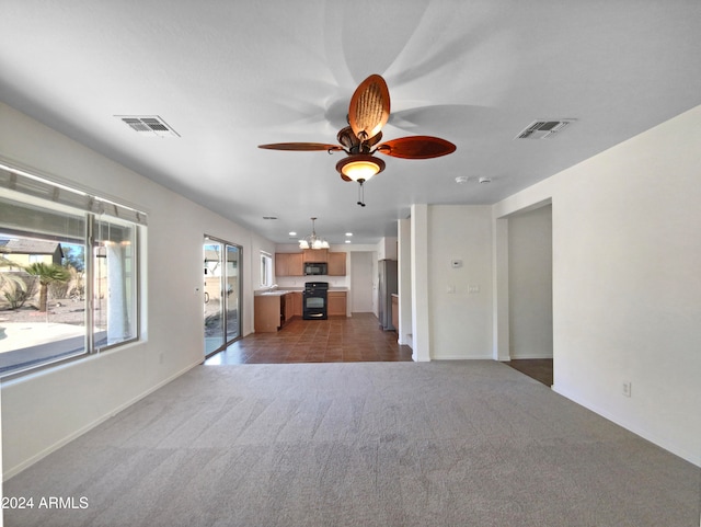 unfurnished living room with ceiling fan with notable chandelier and dark carpet