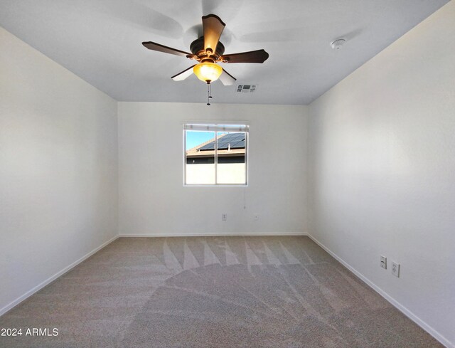 unfurnished room with ceiling fan and carpet