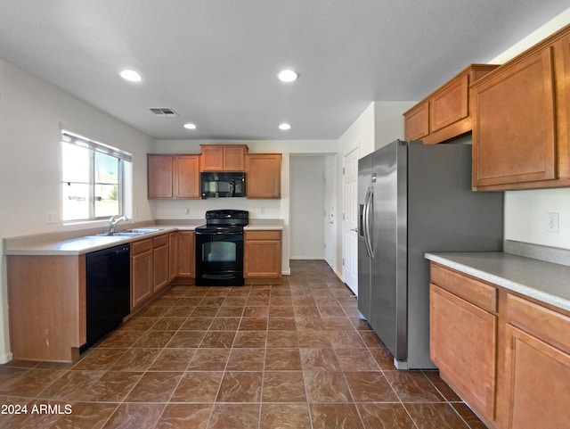 kitchen with sink and black appliances