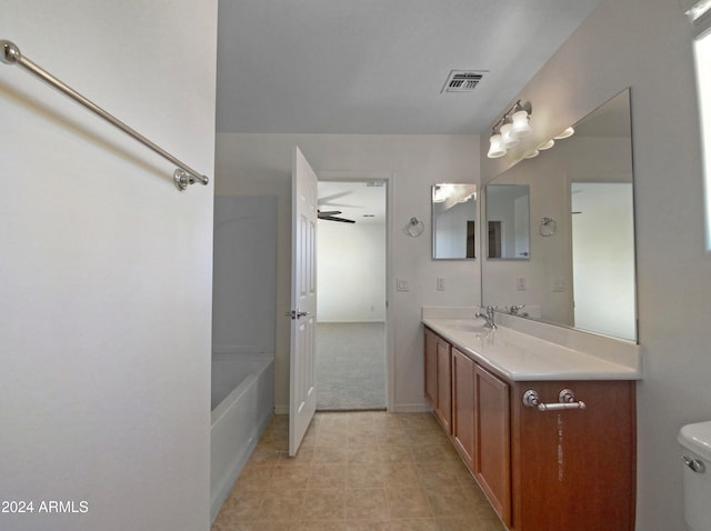 bathroom featuring tile patterned floors, vanity, toilet, and ceiling fan