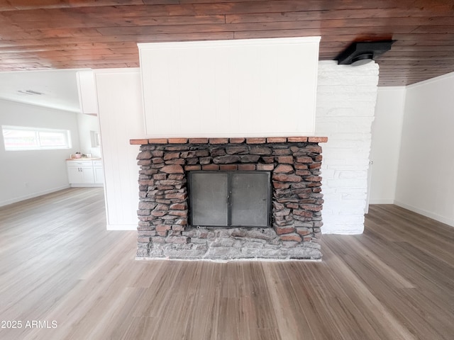 room details featuring baseboards, a fireplace, visible vents, wooden ceiling, and wood finished floors