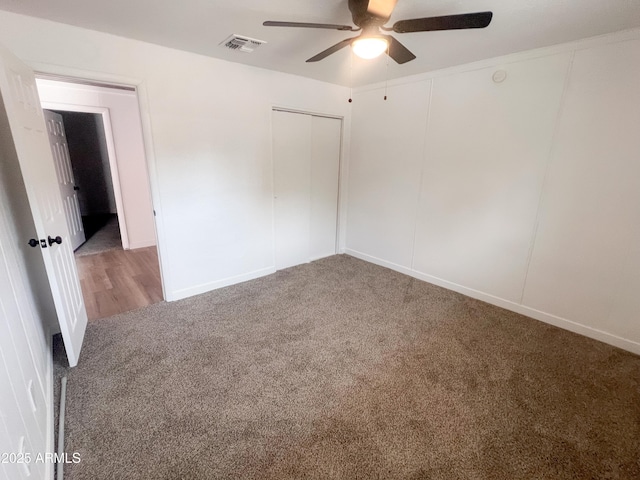 spare room with visible vents, ceiling fan, carpet floors, and baseboards