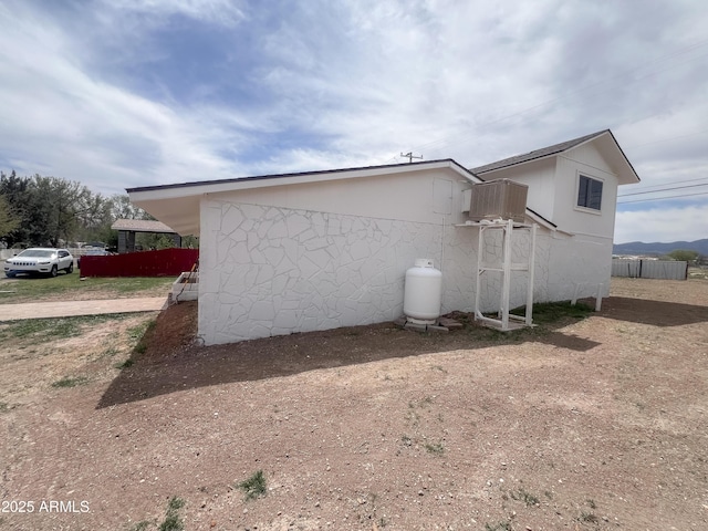 view of side of home with fence