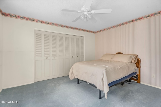 carpeted bedroom featuring ceiling fan, a closet, and baseboards