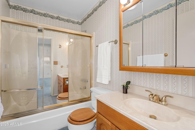 full bathroom with toilet, wallpapered walls, enclosed tub / shower combo, and vanity