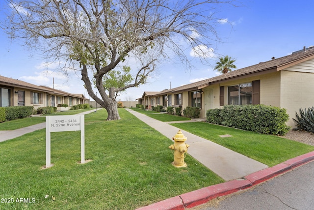 surrounding community with a lawn and a residential view