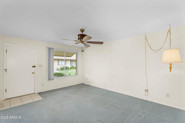 interior space featuring a ceiling fan, carpet, and a textured ceiling