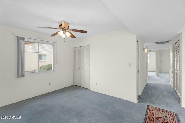 empty room featuring carpet floors and visible vents