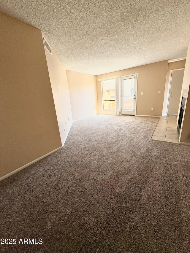 11640 N 51st Ave Unit 248, Glendale, AZ 85304 - unfurnished room featuring light colored carpet, a textured ceiling, baseboards, and visible vents