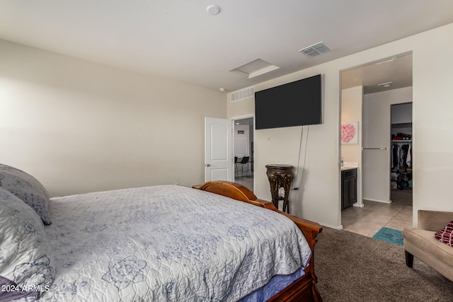 bedroom featuring ensuite bath and light tile patterned floors