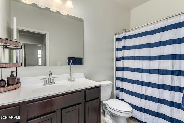 bathroom with vanity, toilet, and a shower with shower curtain