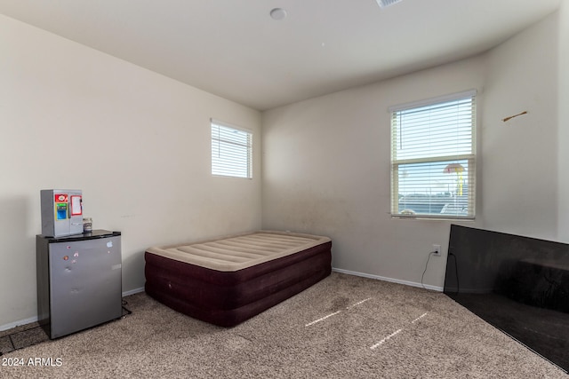 bedroom featuring light carpet