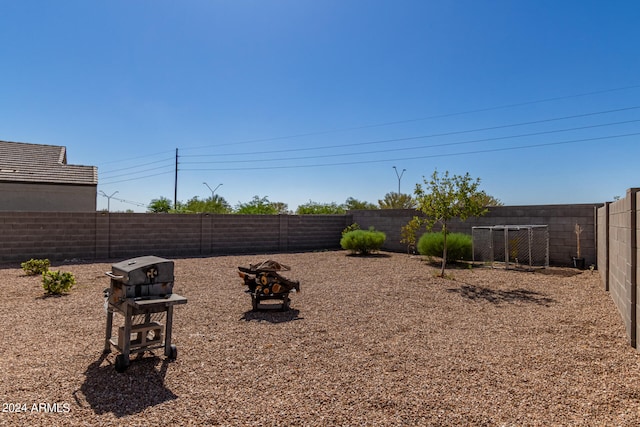 view of yard featuring an outdoor fire pit