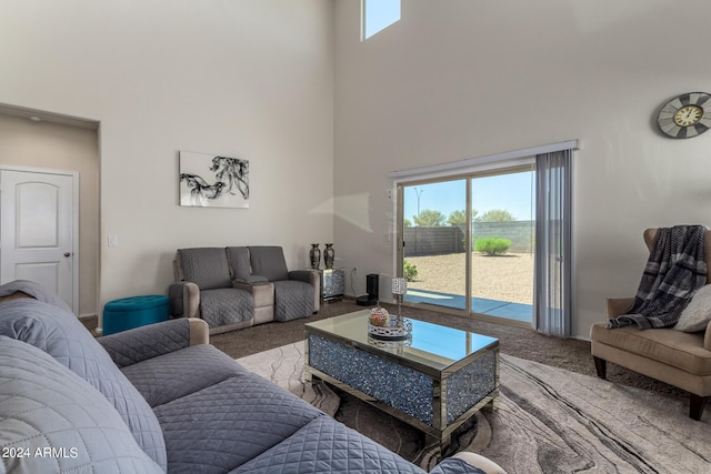 carpeted living room featuring a high ceiling