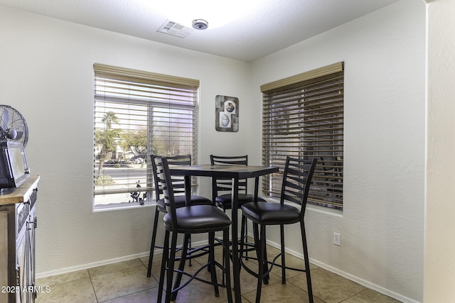 tiled dining room with plenty of natural light