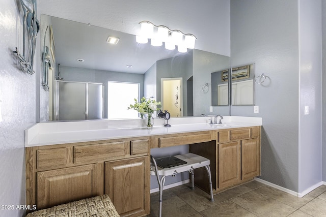 bathroom featuring a stall shower, tile patterned flooring, vanity, and baseboards