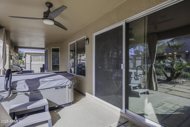 view of patio / terrace with a ceiling fan and fence