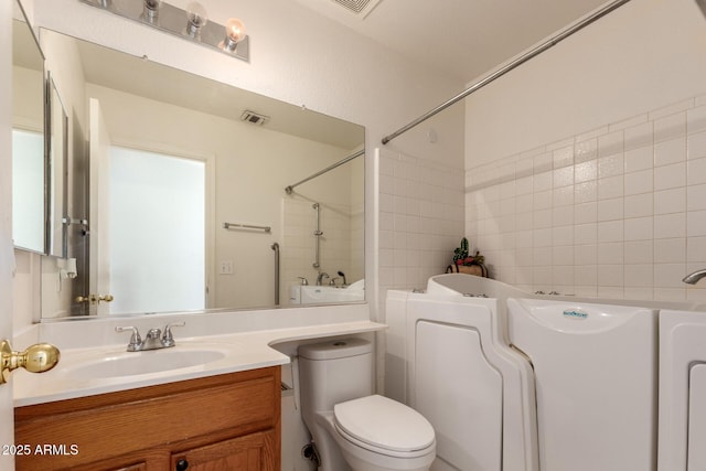 full bathroom with toilet, vanity, and independent shower and bath