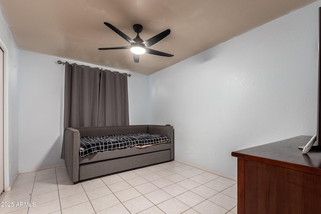 bedroom with ceiling fan and light tile patterned flooring