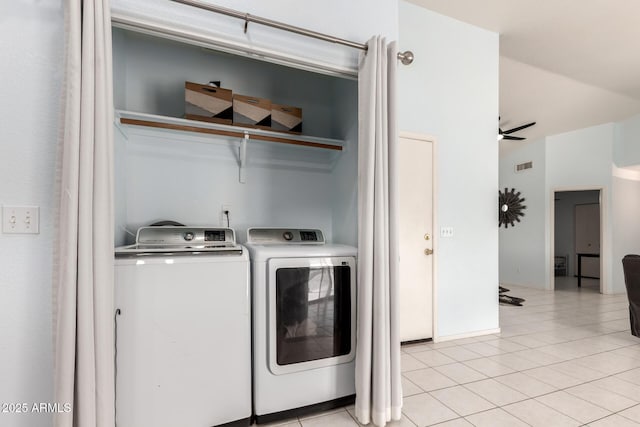 laundry room with ceiling fan, light tile patterned floors, and washer and clothes dryer