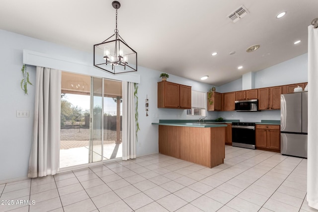 kitchen with decorative light fixtures, vaulted ceiling, kitchen peninsula, appliances with stainless steel finishes, and a chandelier