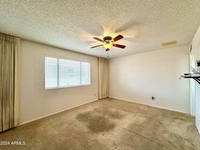 unfurnished room featuring carpet flooring, a textured ceiling, and ceiling fan