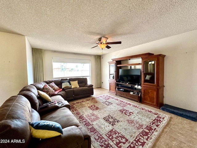 living room with ceiling fan and a textured ceiling