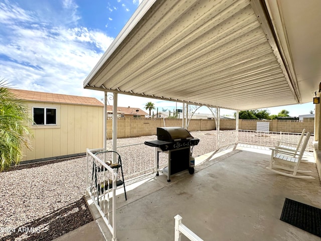 view of patio / terrace featuring area for grilling and a storage unit