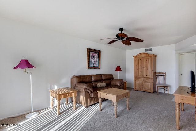 living room with ceiling fan and carpet