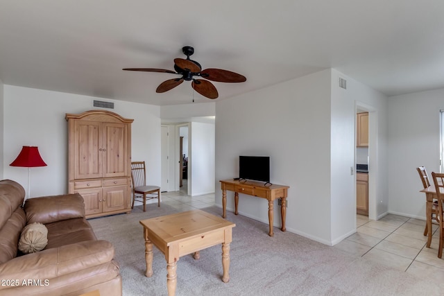 tiled living room featuring ceiling fan