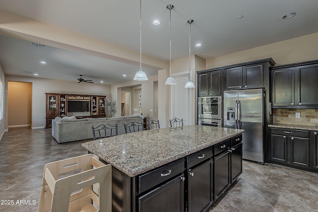 3925 E Elmwood St, Mesa, AZ 85205 - kitchen with stainless steel fridge, ceiling fan, a center island, backsplash, and hanging light fixtures