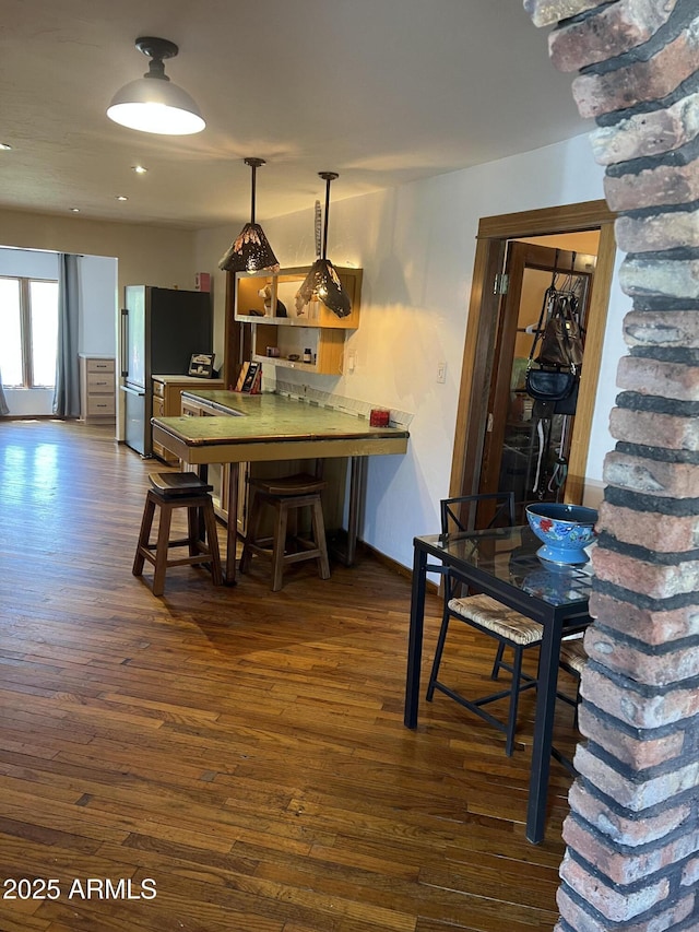 dining room featuring recessed lighting, baseboards, and dark wood finished floors