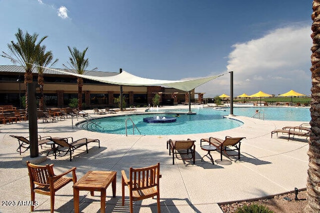 community pool with a patio area